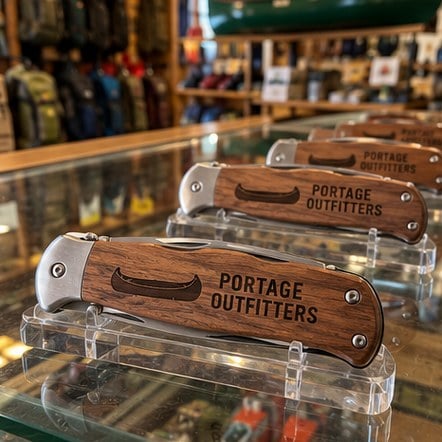 Custom folding knives in an outdoor store counter display